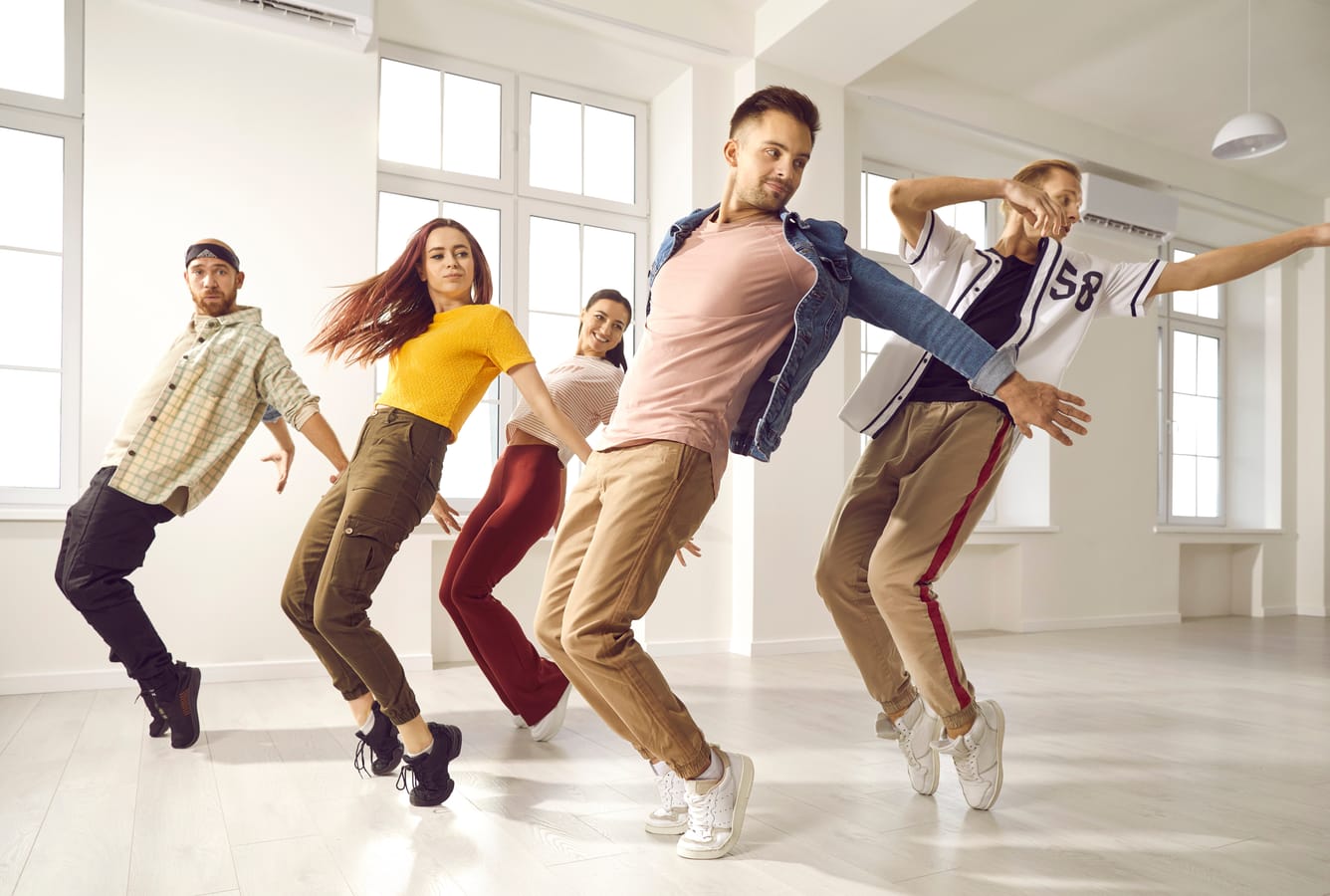 Hip hop dance crew rehearsing in a modern professional studio