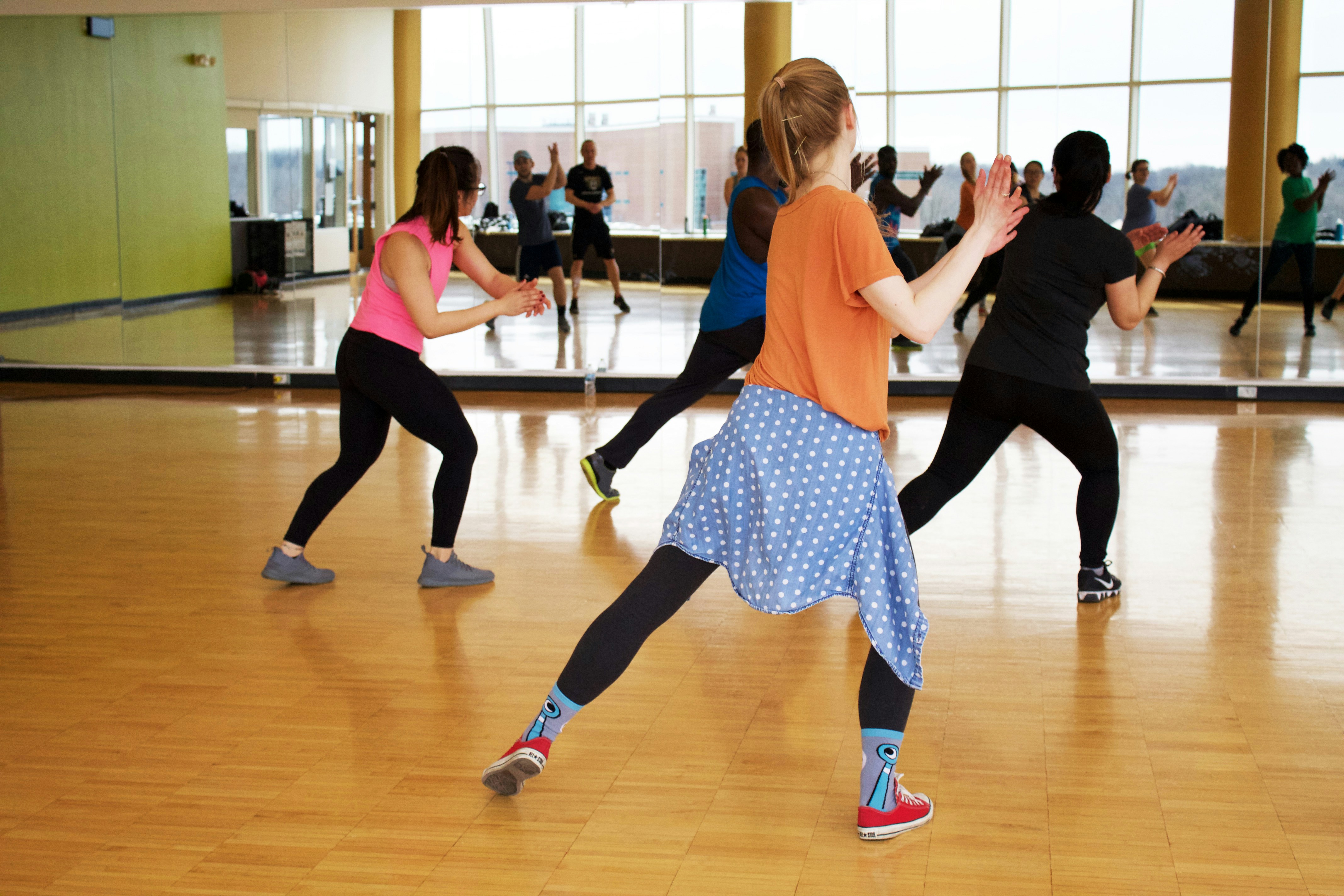 K-Pop dance class in session — students practising in front of studio mirror